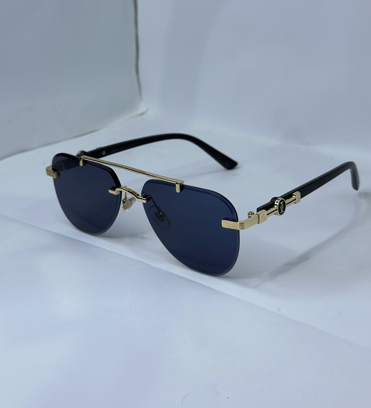 Cartier CT0291S Rimless Aviator Navy Blue Gold - Lifestyle White Surface Three Quarter Real Photo