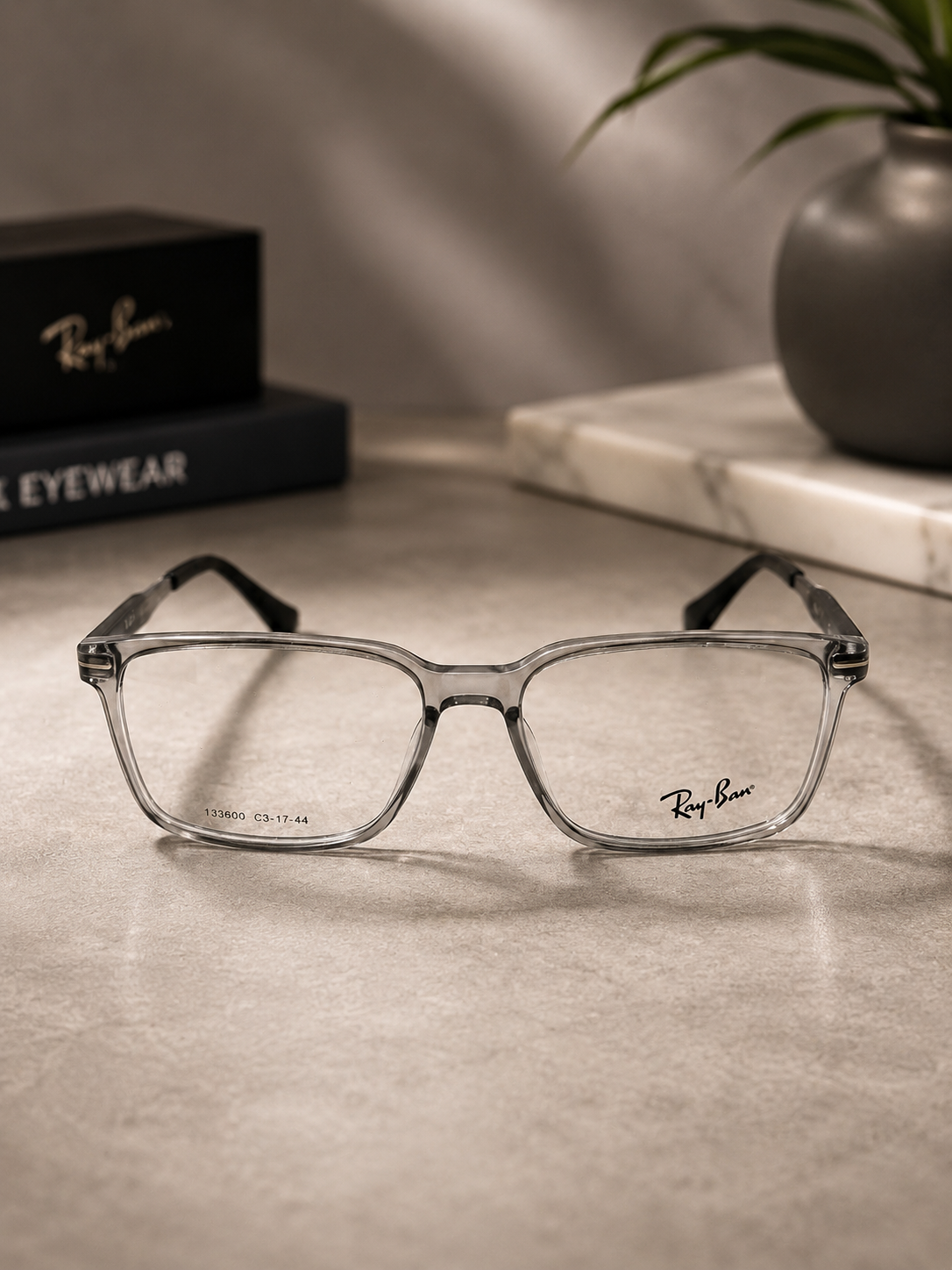 Ray-Ban Rectangular Eyeglasses Transparent Grey - Lifestyle Desk with Ray-Ban Box