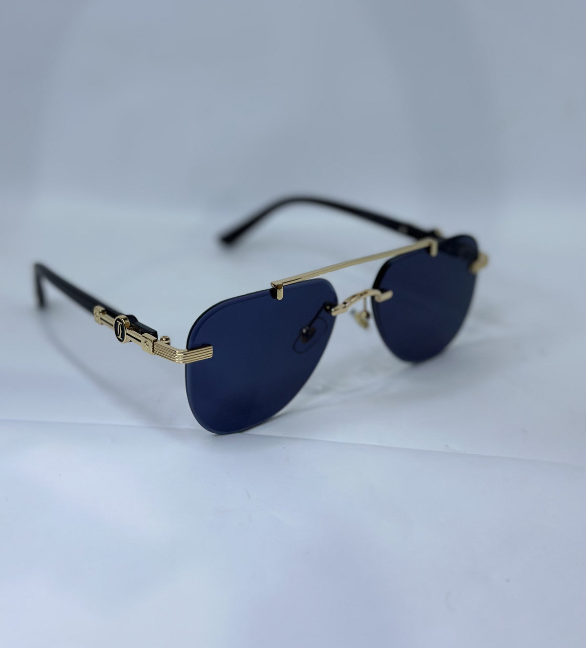 Cartier CT0291S Rimless Aviator Navy Blue Gold - Lifestyle Grey Surface Side Angle Real Photo